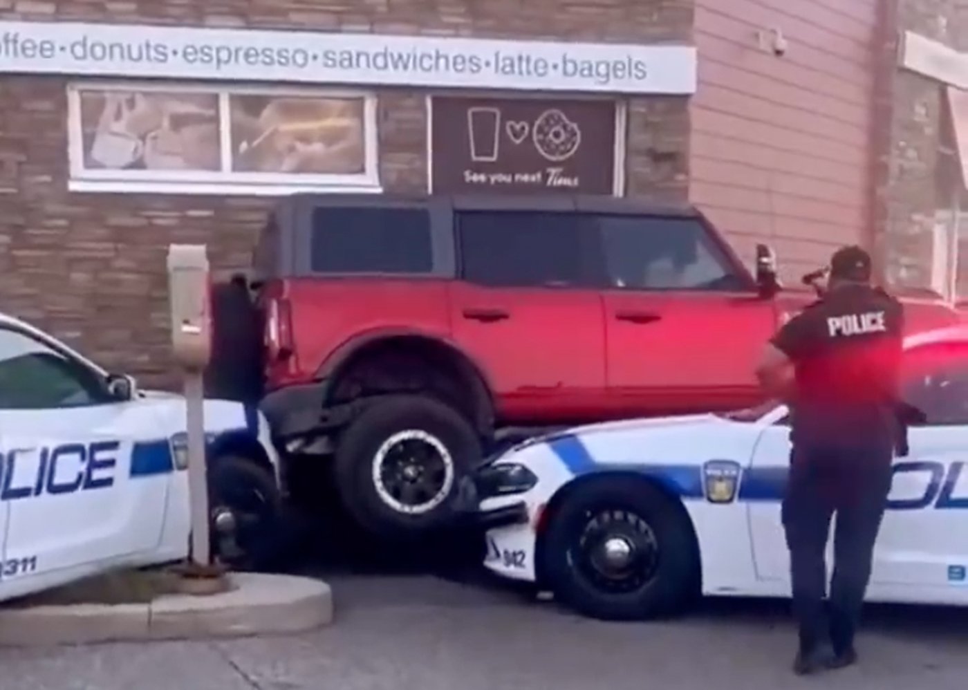 Man arrested after officers buck Bronco truck’s attempt to drive over police cruisers